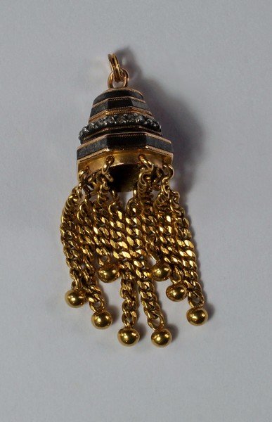 A yellow and oxidized metal diamond set pendant, of: A yellow and oxidized metal diamond set pendant, of bell form, alternating discs of unmarked yellow metal and oxidized metal with a band of mine cut diamonds, hung with flat curb link tassels, approx 