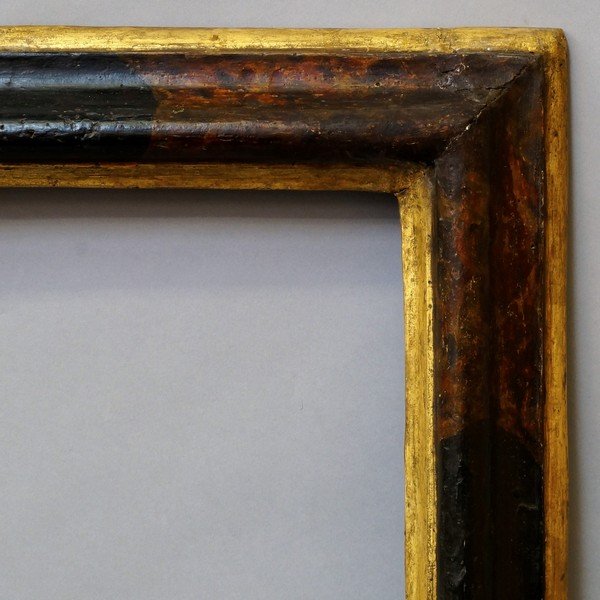 An Italian Polychrome and Parcel Gilded Bolection: An Italian Polychrome and Parcel Gilded Bolection Frame, 17th century, with cavetto sight, reverse ogee and ovolo back edge, 66.5x50cm