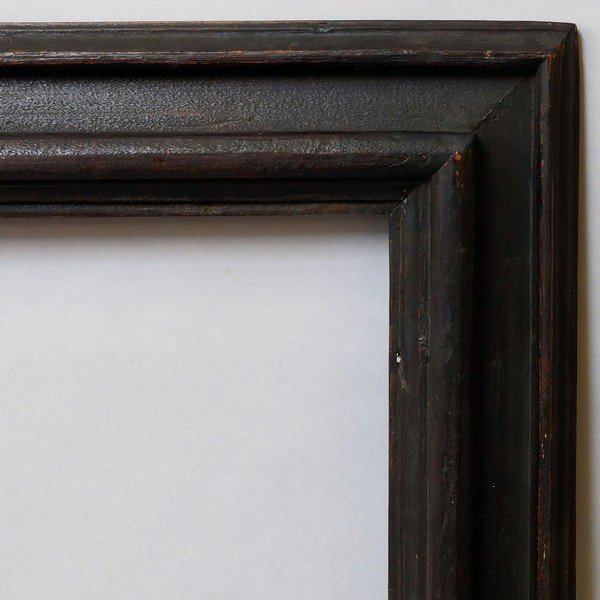 An Italian Ebonised Moulding Frame, 17th century, with: An Italian Ebonised Moulding Frame, 17th century, with plain sight, torus front edge, reverse wedge hollow and ogee back edge, 75x61.5cm