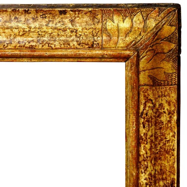 An Italian Polychrome Painted and Parcel Gilded Carved: An Italian Polychrome Painted and Parcel Gilded Carved Frame, late 17th/early 18th century, plain sight, bead and bar, reverse ogee with hand-tooled flower head centres and foliate corners, plain step