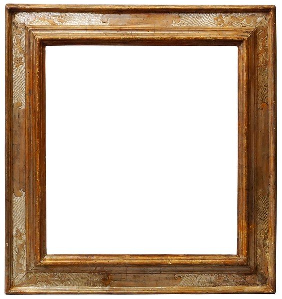 An Italian Carved and Silvered Cassetta Frame, 17th: An Italian Carved and Silvered Cassetta Frame, 17th century, with cavetto sight, torus front edge, reverse wedge frieze with panel centres and hand tooled foliate corners on a hatched ground ogee back