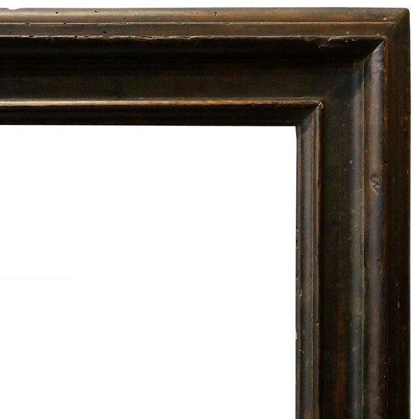 A Dutch Ebonised Nutwood Cassetta Frame, 17th century,: A Dutch Ebonised Nutwood Cassetta Frame, 17th century, with cavetto frame, ogee, plain frieze and plain top knull, stepped and ovolo back edge, 57.5x73cm