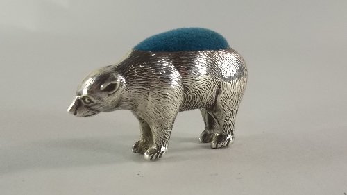 A silver novelty pin cushion, Birmingham c.1925, Adie &: A silver novelty pin cushion, Birmingham c.1925, Adie & Lovekin Ltd, in the form of a polar bear, with realistically modelled fur, approx 4cm high x 7cm long.
