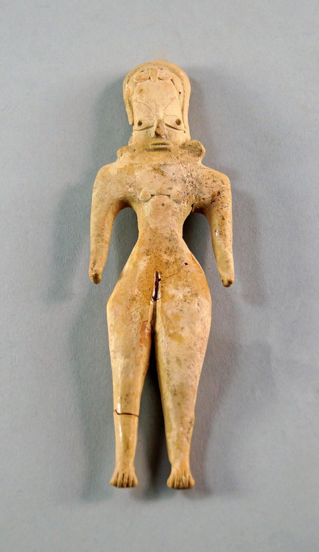 A Syrian Terracotta female idol, c. 2000 B.C. possibly: A Syrian Terracotta female idol, c. 2000 B.C. possibly a fertility figure, wearing stylised head-dress and features, with arms and legs apart, 16cm high