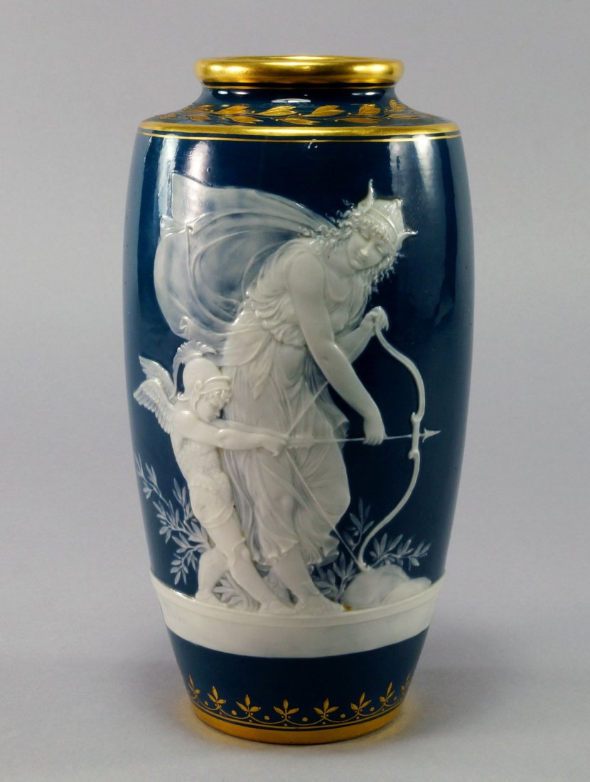 A Minton pate sur pate vase by Alboin Birks, late: A Minton pate sur pate vase by Alboin Birks, late 19th/early 20th century, decorated with a vignette depicting Venus and Cupid at an archery lesson, with a ribbon hung ivy strewn cluster of arrows, a 