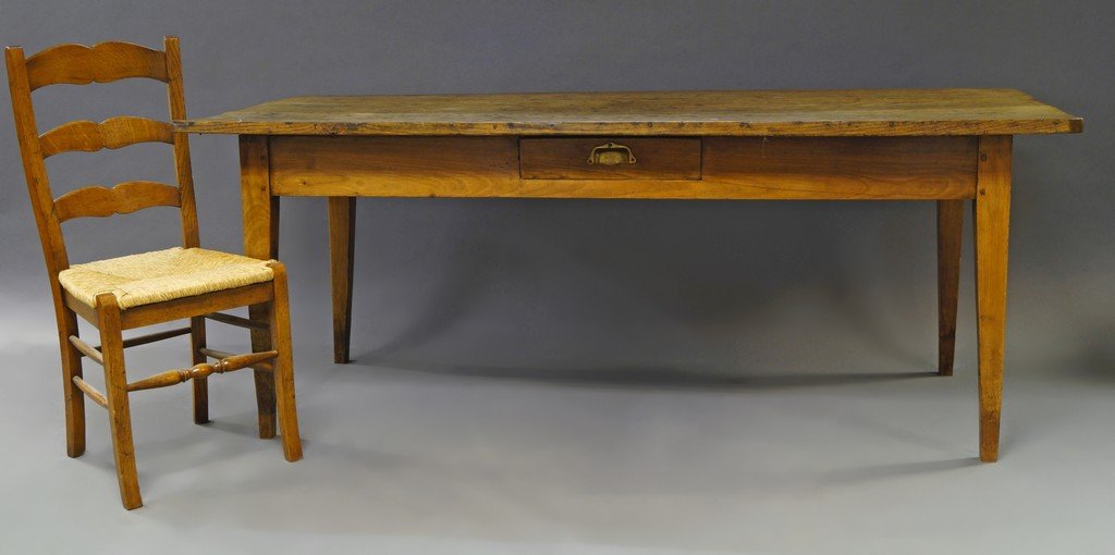 A rectangular elm and fruit wood farmhouse table, 19th: A rectangular elm and fruit wood farmhouse table, 19th century, with frieze drawer, on square tapering legs, 77cm high x 200cm long x 83cm deep, together with six ladder back chairs, with woven reed s