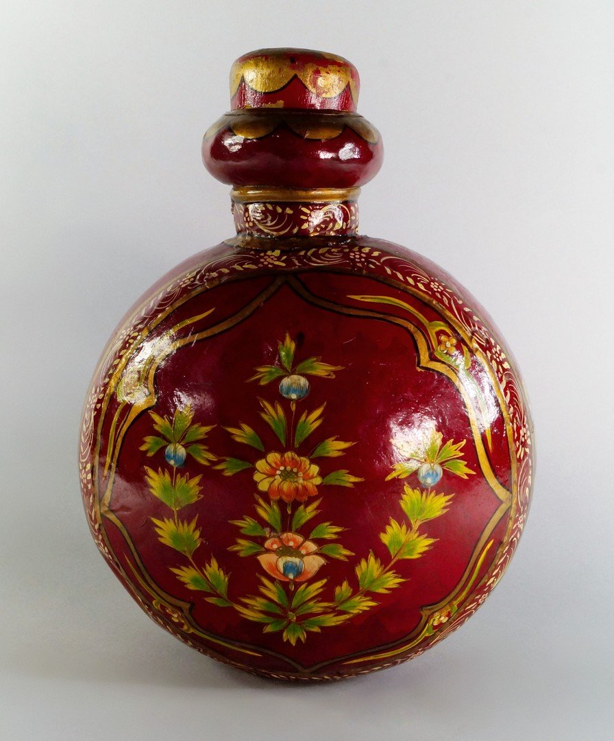A large Turkish painted metal water flask, late: A large Turkish painted metal water flask, late 19th/20th century, painted with panels of flowers to front and back and sides within gilt line frames, on red ground, 33cm high