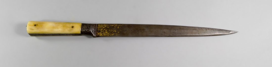 A Turkish steel and bone dagger, 17th century, the hilt: A Turkish steel and bone dagger, 17th century, the hilt engraved with foliate decoration, the watered steel blade tapering to a rounded point, decorated with foliate damascening and feint inscription 
