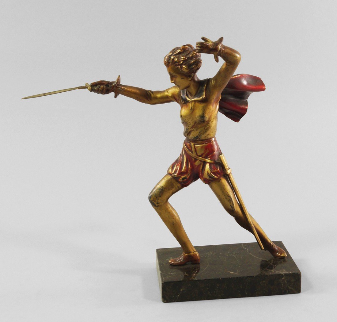 An Art Deco cold painted figure of a female fencer,: An Art Deco cold painted figure of a female fencer, 1930s, upon marble base, approx 22cm high.