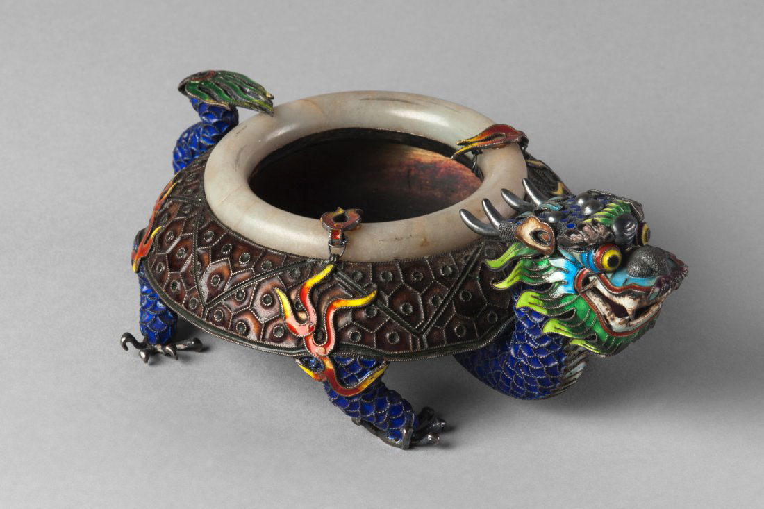 A Chinese silver, enamel and hardstone mounted dragon: A Chinese silver, enamel and hardstone mounted dragon form washer, mid 20th century, the rim set with a pale green jade ring, stamped 'Made in China, Silver', 17.5cm long