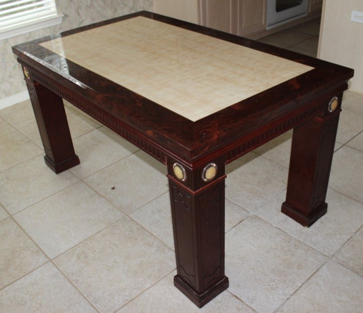 Marble top dinning table on Rosewood base: Marble top dinning table on Rosewood base with round stone medallion details on each leg. Size: 32" H x 59" W x 36" D. (one white round medallion is missing on a leg)