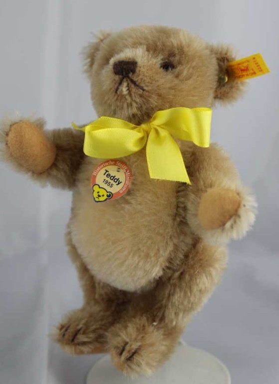 Steiff Teddy Bear - Teddy (1955) Mini-90: Steiff Teddy Bear - Teddy (1955) Mini-90. Jtd. caramel mohair bear with flannel paw pads. Yellow elephant historic chest tag, "Teddy 1955". Yellow ear tag and yellow ribbon neck bow. Size: 6" H