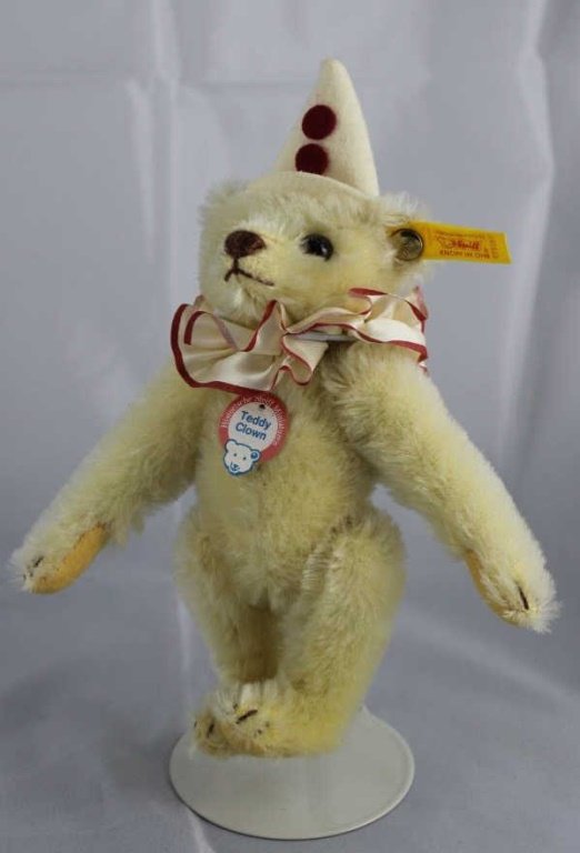 Steiff - Teddy Clown-188: Steiff - Teddy Clown-188 in the box. White cone hat with red pom poms. White ruffle trimmed in red. Yellow elephant historic chest tag. Size: 6" H Excellent condition.