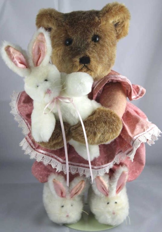 Bunny Hugs-272. Patty Downing-Patty's Bears. In sy: Bunny Hugs-272. Patty Downing-Patty's Bears. In synthetic-multi-hued brown standing at 13" H and in excellent condition. The bear is dressed in mauve patterned PJ's holding a bunny doll and wearing wh