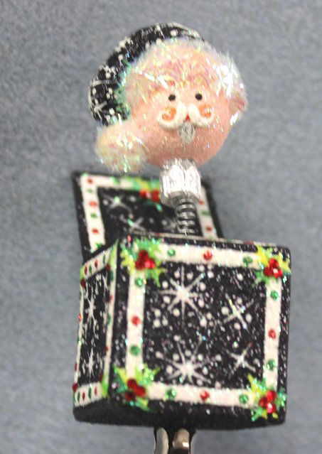 Patricia Breen "Jolly Surprise Santa" Ornament: Patricia Breen "Jolly Surprise Santa" black Christmas ornament. Bergdorf Goodman exclusive. Ltd. to 84. A Santa head jack-in-the-box clip on. A fully glittered black background with crystal accents in
