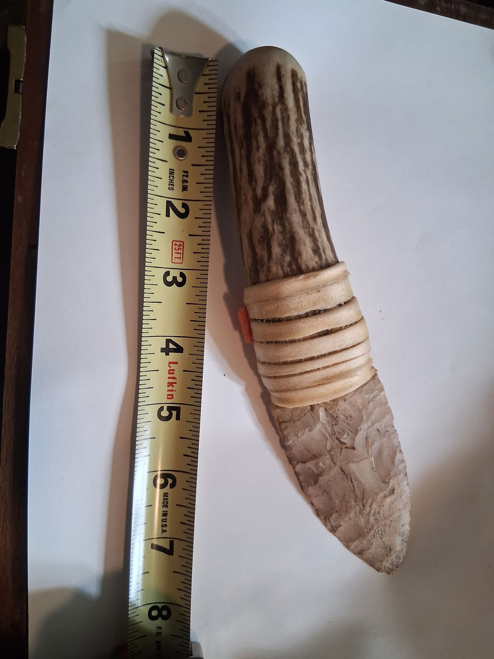 8 Inch Knife: Stone knife placed in a sinew wrap to show like mounting and use.