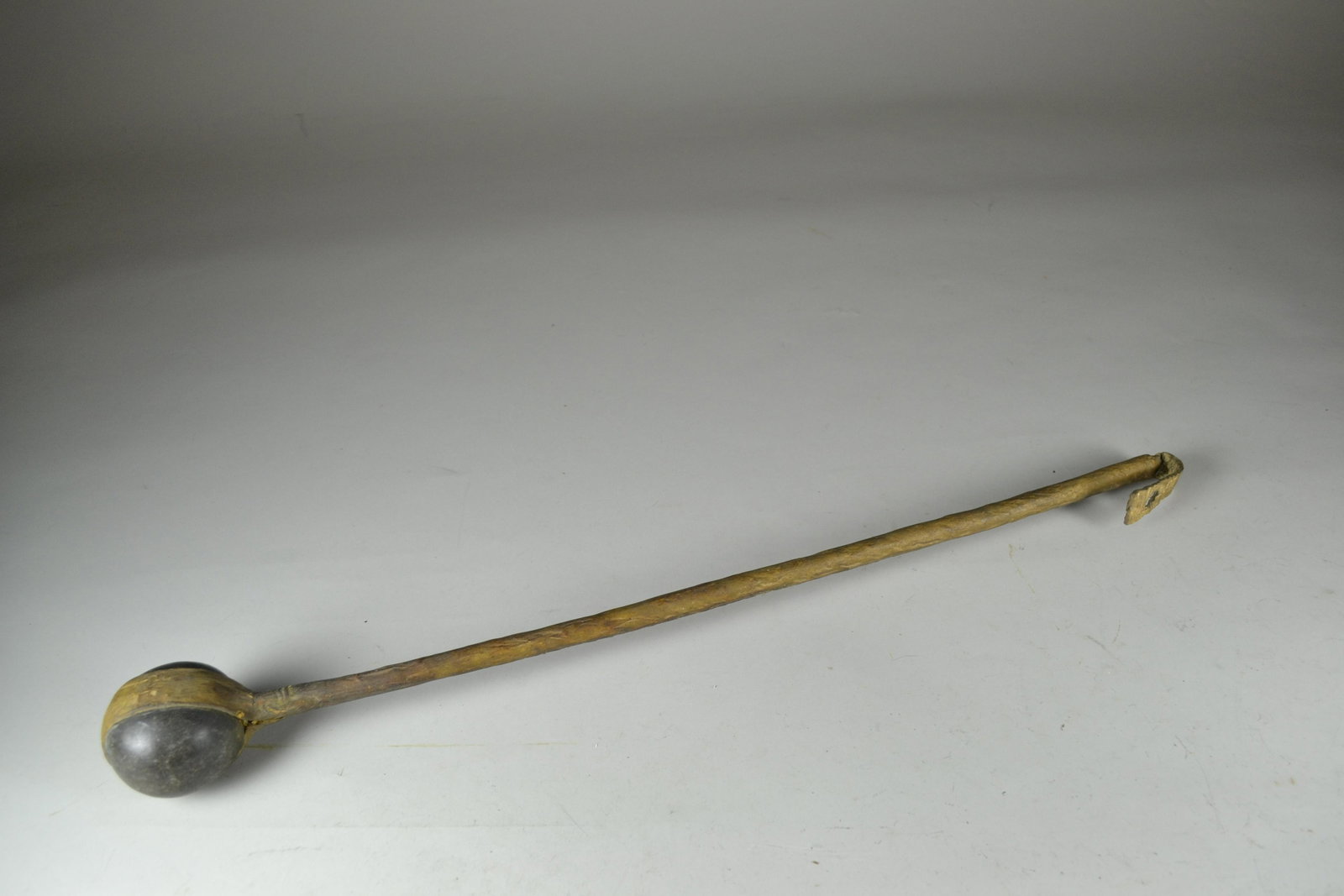 Plains Indians Stone War Club: rawhide wrapped shaft with round stone head. Minor wear. 24" l x 2 3/4" w head
