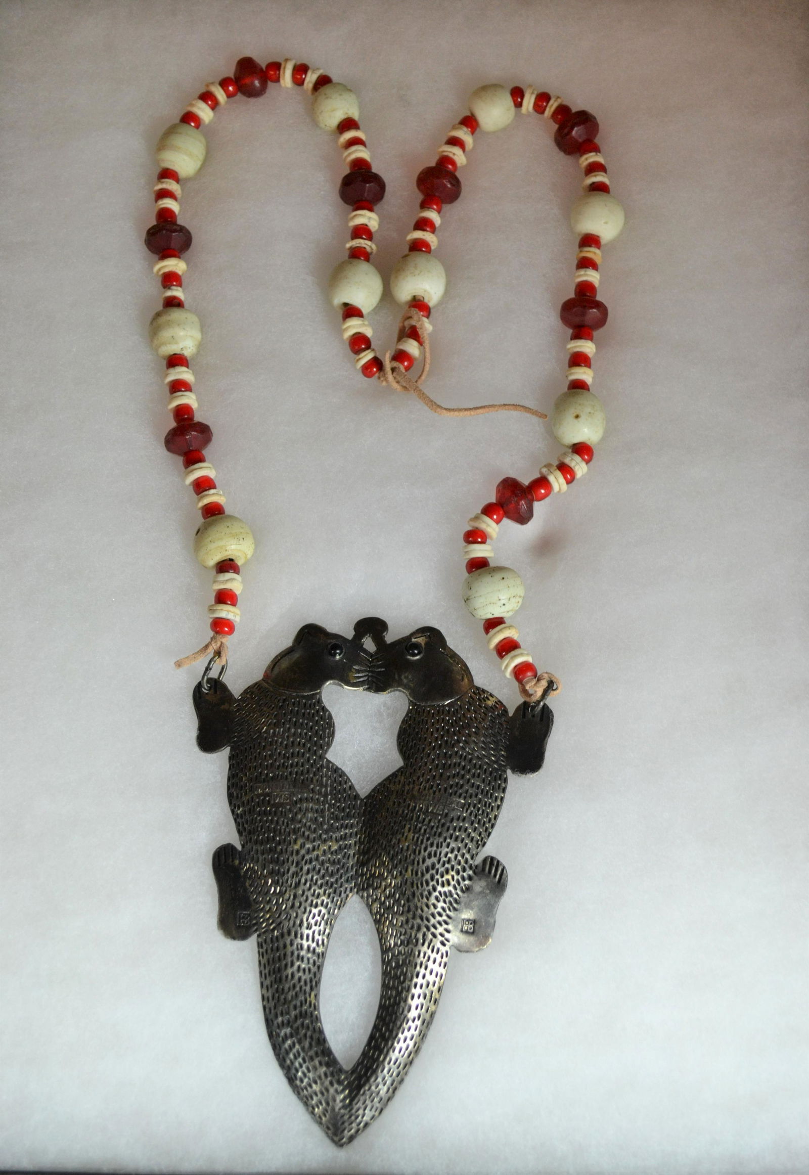 Hudson Bay Fur Trade Kissing Otters Gorget: otters stamped Montreal WS and have HB on lower foot. Necklace is of stone and glass beads. Otters have glass eyes. Minor wear. Otters 6" h