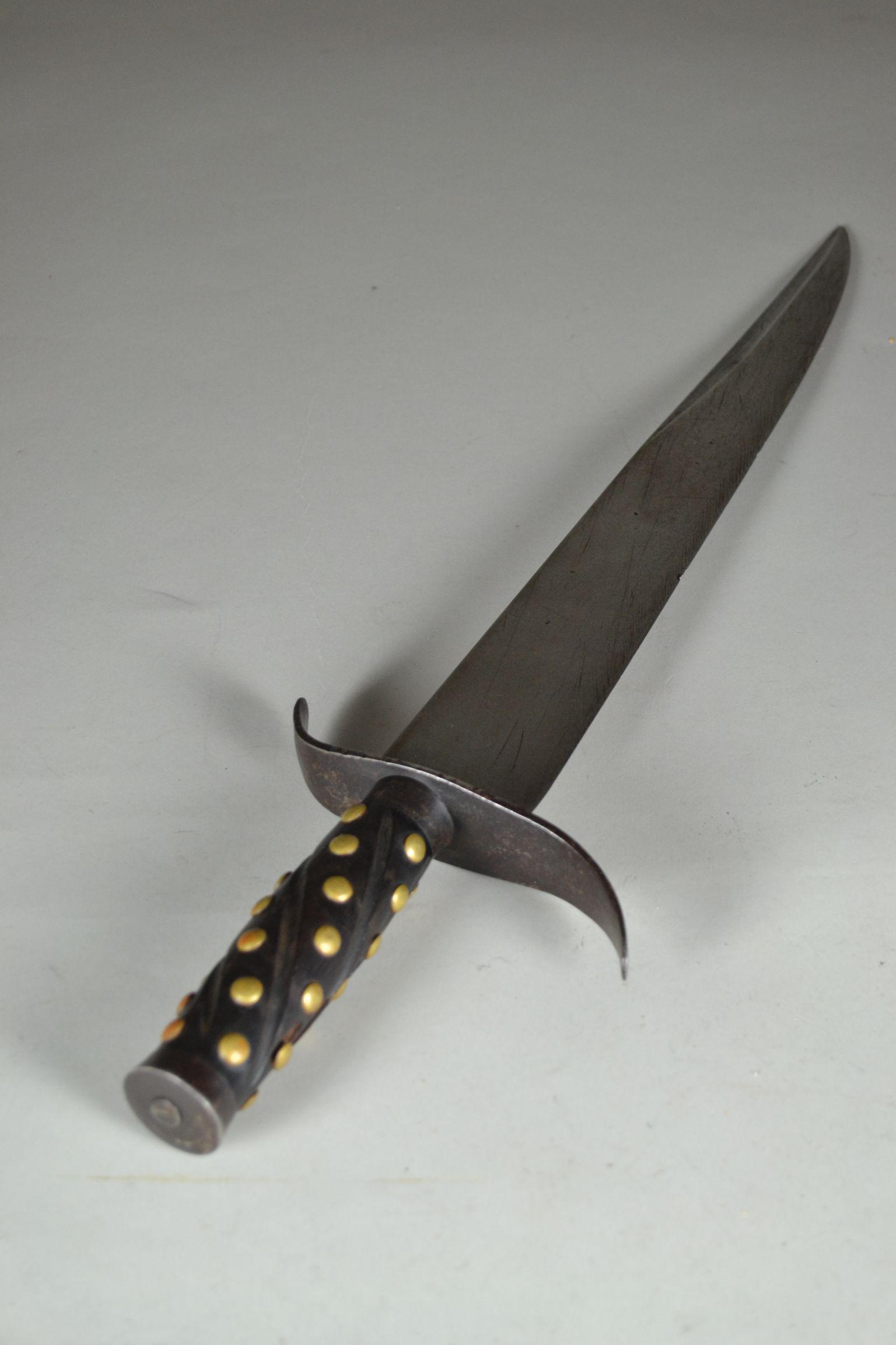 Vintage Thick Bladed Clip Point Bowie Knife: with iron cross guard. Has iron ferrule and pommel. Wood grips are decorated with brass tacks. Blade edge is chipped and has marks of being incorrectly sharpened. Spine is 7/16" thick. Pitting to iron