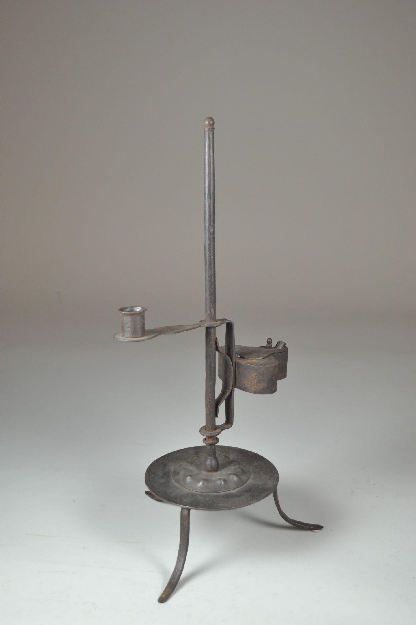 19th Century Wrought Iron Lighting Device: with Betty lamp and candle cup. Adjustable height. Lite pitting throughout. 16 1/2" h