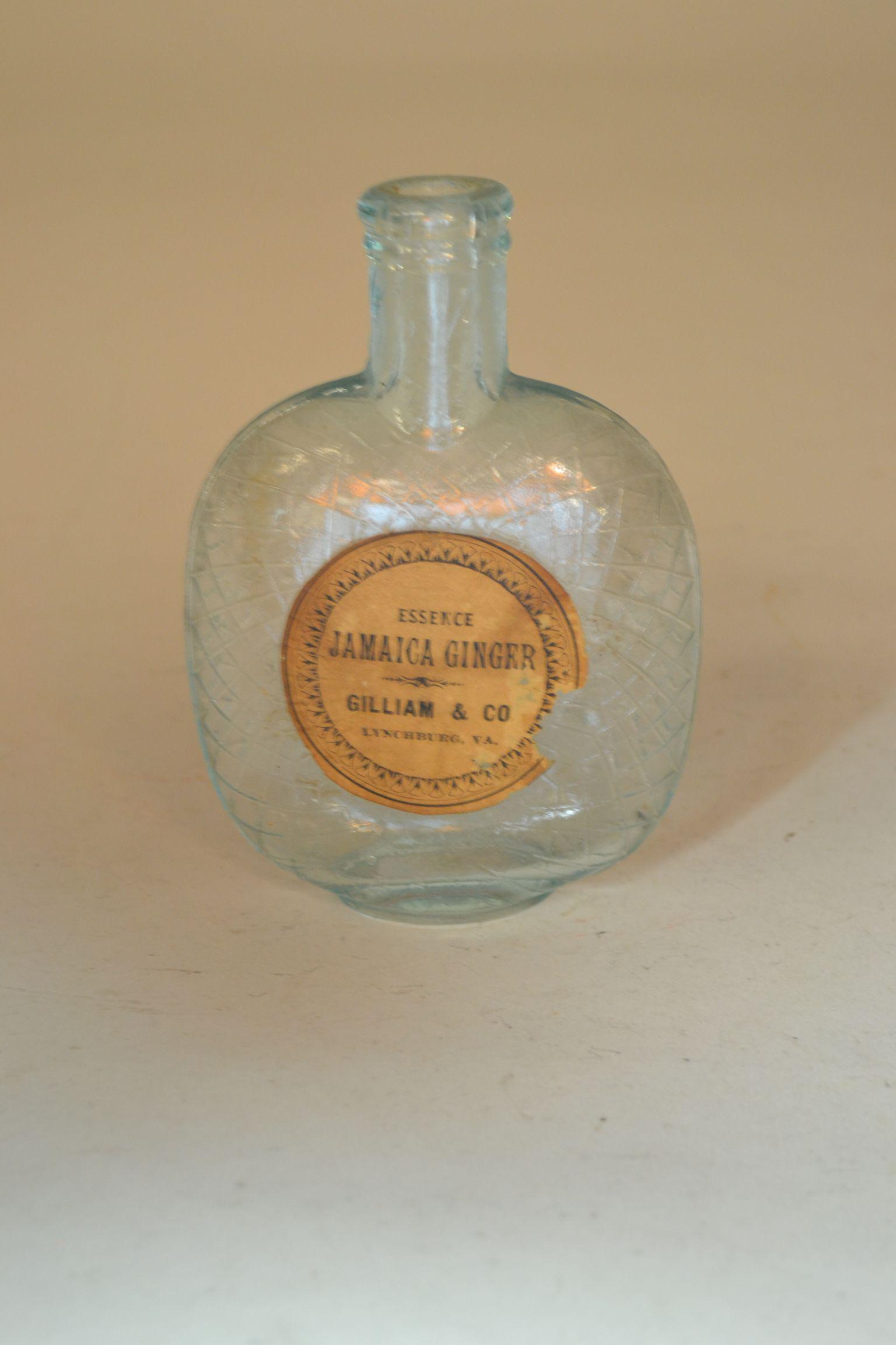 1880s Pumpkin Seed Flask: with paper label. Label reads Essence Jamaica Ginger Gilliam & Co. Lynchburg, VA. Approximately 90% intact. Small chips in base of flask. 5 1/2" h