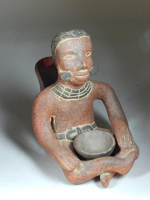 Mayan Style Seated Terracotta Figure/Incense Burner: has large chip in incense holder on back of figure. Small bowl in lap is not attached and chipped. Wear to finish. 9" h x 7" w x 10" d