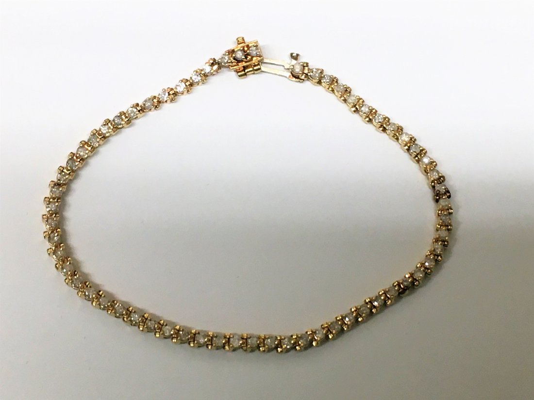 14K Yellow Gold & Diamond Tennis Bracelet: approximately 1 1/2" cts tw, 7 1/2" long, a few links are stretched, 8.6 grams tw