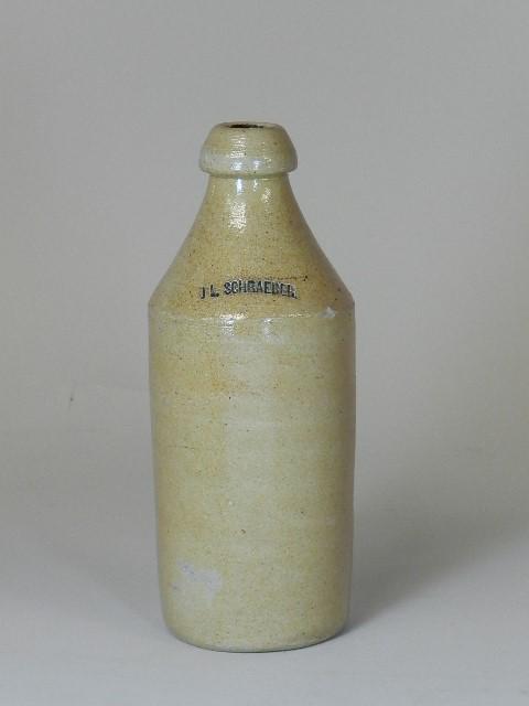 J.L. Schraeber Stoneware Ginger Beer Bottle: stamped maker mark with cobalt added to lettering. Small chip on shoulder, otherwise excellent condition