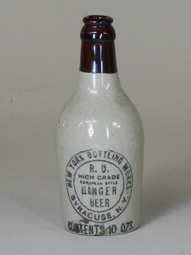 New York Bottling Works Syracuse, NY Ginger Beer Bottle: has crown top, crazing to finish and edge chip on bottom, 7" h
