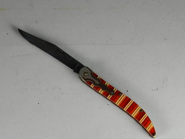 Case XX 10095 Pocket Knife: with multicolored Lucite handles. Top of blade has lite pitting. Minor wear/scratches to handles, 5" long closed