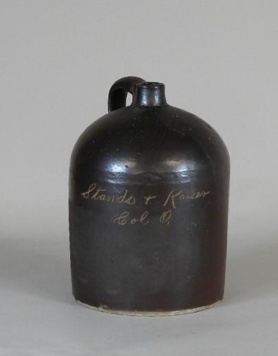 Stands & Kaiser Columbus Ohio Stoneware Jug: Albany glaze with name scratched into glaze. Few minor chips on bottom, edge wear, minor wear. 12 1/2" h x 9" w