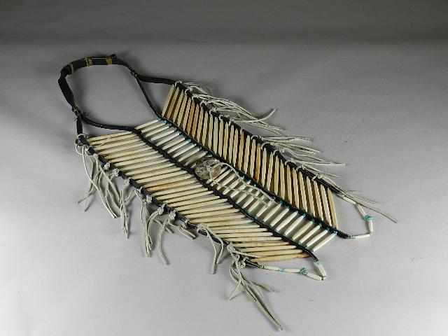 Traditional Bone Breast Plate: made with 3 1/2" and 2" bone hair pipe and turquoise, 2" abalone shell in center. Sinew used to tie leather for neck piece to main body, excellent condition. Approximately 28" h x 10" w