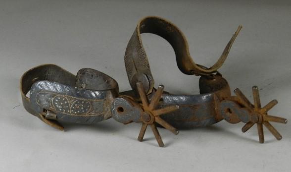 Early 20th Century Pair of Chihuahua Mexican Spurs with: heavy wear from use with some loss of inlay. Has copy of old tag from Harry Knight. From the Estate of Harry Knight, a member of the Buffalo Bill Wild West Show, owner of the first American Dude Ranch