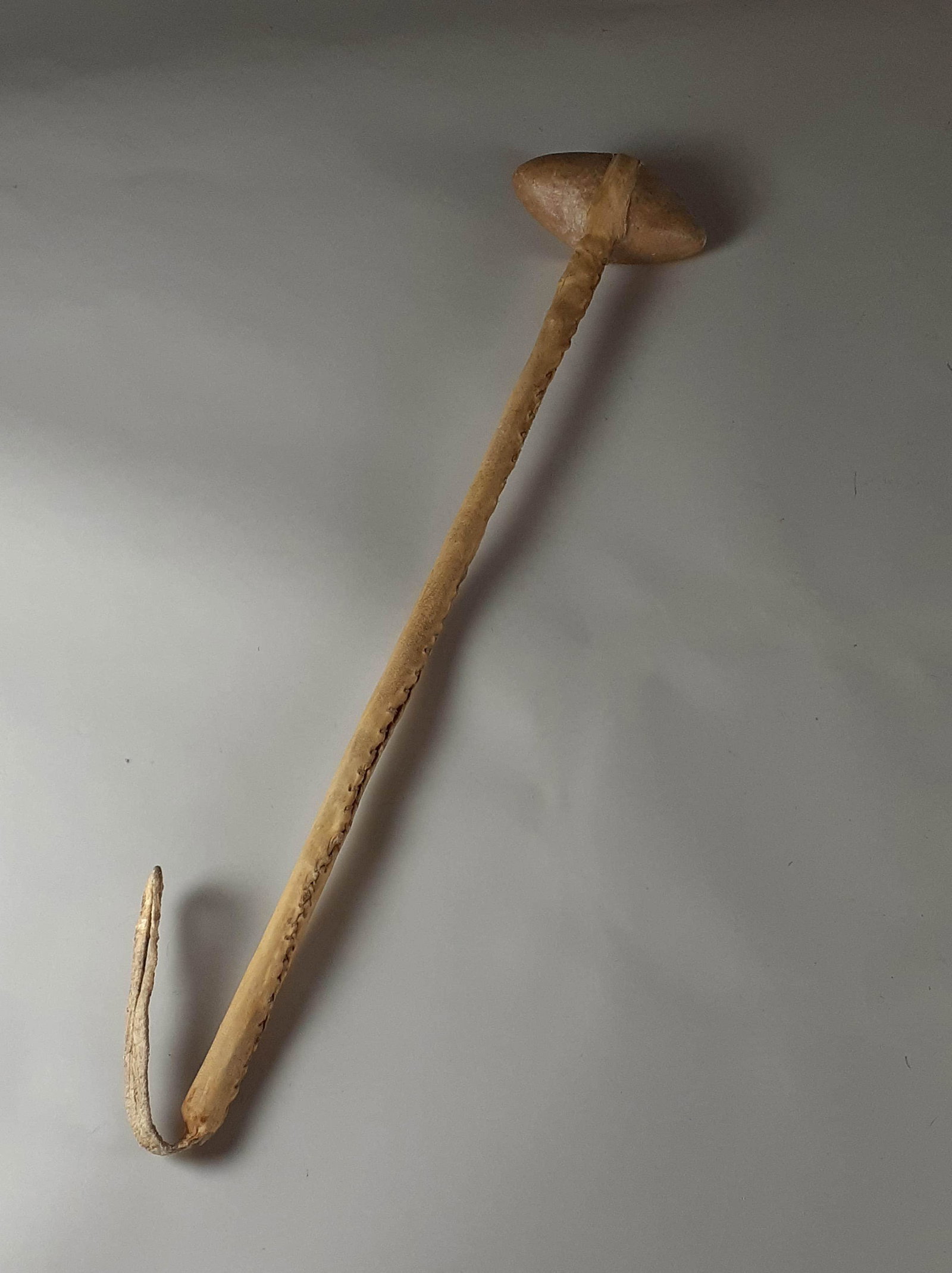 Early 20th Century Ceremonial or Dance Stone War Club: made with hide and sewn with sinew. Rock is shaped and has damage to each end from striking the ground. Wear from use, 21" long. From the Estate of Harry Knight, a member of the Buffalo Bill Wild West