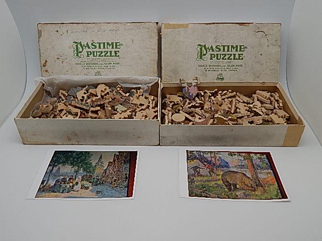 Two 1930's Parker Brothers Pastime Wooden Puzzles: "Quaint Old Holland" and "An Uninvited Guest." Boxes show heavy wear. Both appear to be complete but not guranteed. Wear from use, Holland is 10 1/2"h x 13 3/4" w
