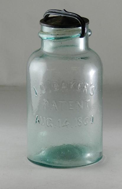JC Bakers Patent Aug 14 1860 Quart Aqua Jar: with J.C Baker marked lid that is heavily pitted. Yoke is a reproduction. RB# 181-1, minor wear, 7 1/2" h