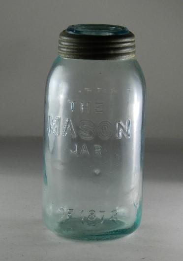 The Mason Jar of 1872 Half Gallon Aqua Jar: RB# 1750, made by Whitney. Correct 1872 dated glass lid, small chip on lip, 3/8" wide chip in lid, 9" h