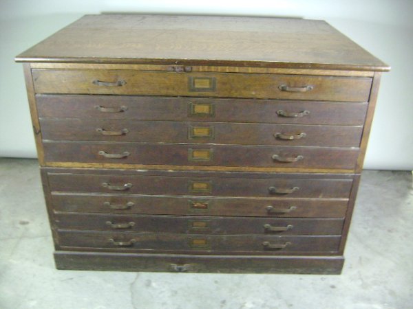 Oak Map Cabinet: Two piece construction, four drawers in each section for a total of eight drawers. Original hardware. Missing original center locking bar. Original finish, solid construction. English registry mark 19