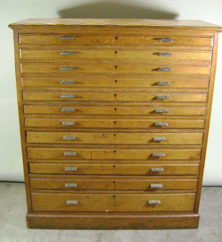 Oak Map Cabinet: 12 drawers, one piece construction, dovetail drawers. Top drawer has original makers label "Maple & Co London Paris Buenos Aires. Original hardware and finish. 54 1/4" h x 48" w x 19 1/2" d.