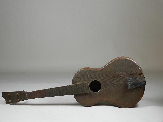 Handmade Early 20th Century Tenor Guitar: has paper label that says Handmade by Arthur Miller Horseshoe NC. Tiger maple back, crack in front and one replaced peg, no strings, 26" long