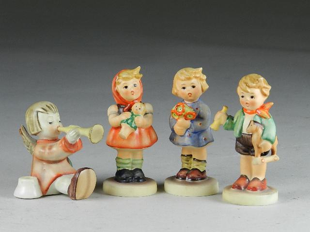 Lot of 4 Goebel Hummel Figures: 293 A,B,C, Girl with flowers, Girl with doll, Boy with horse and Angel with horn. All are trademark 5, candle holder trademark 3. Excellent condition, tallest 3 1/2"