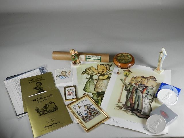 Box Lot of Goebel Hummel Related Items: includes paperwork, prints, 2 ceramic plaques, music box with Hummel picture, gay adventure figure - damaged, and a Madonna HM 245 trademark 2 with repair