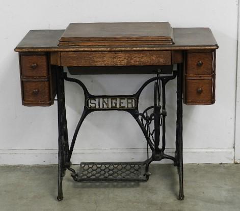 Singer Treadle Sewing Machine: wear to paint and finish, has some attachments, 30" h x 35" w x 17" d