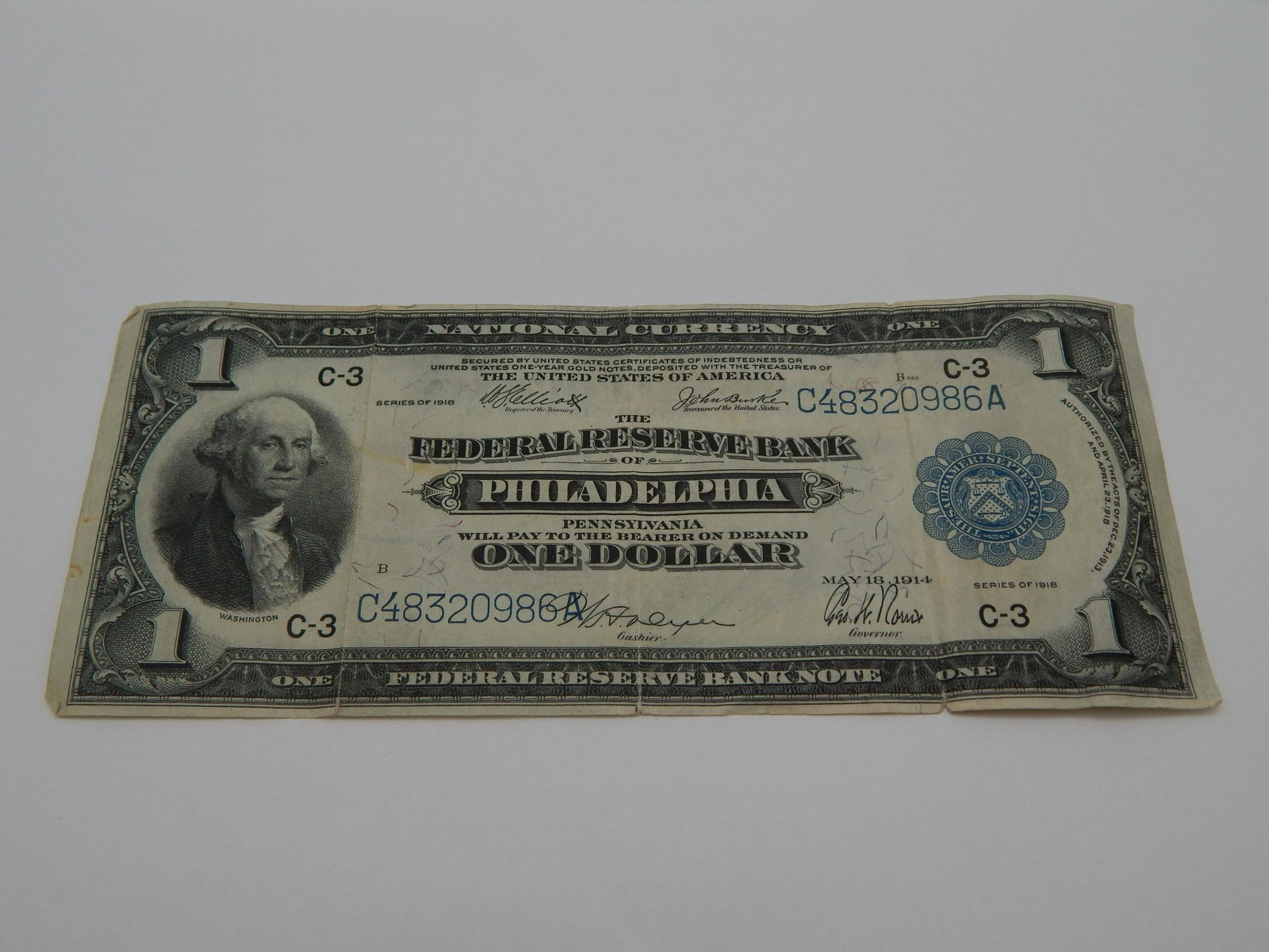 1918 National Currency Note from The Philadelphia: fine with multiple fold lines and torn postage stamp on reverse