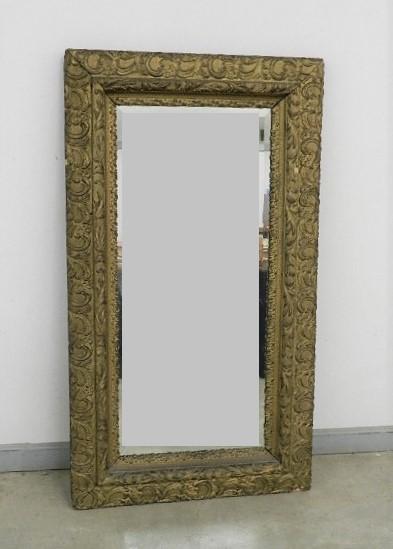 Large Antique Beveled Glass Mirror in Ornate Frame: small areas of loss to plaster decoration, 29" h x 51" w