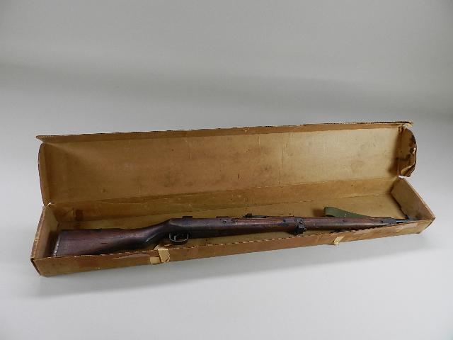 Japanese Arisaka Type 99 Rifle: late war with two piece stock and no hole for cleaning rod. Missing bolt, approximately 50% finish balance is brown with rust. Bore is very good, stock is very good with wear and scratches, mum is gro