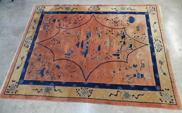 Chinese Peking Style Area Rug: coral field with pagoda, pots, and lotus flowers. Some areas of fading, wear to fringe, pet stains, 9' x 11'8", this item cannot be shipped inhouse