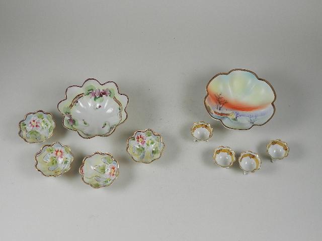 Two hand Painted Nut Dishes: Each has 4 smaller individual bowls. One is marked Nippon. One has been repaired, some with minor chips, Largest 5 1/2? wide