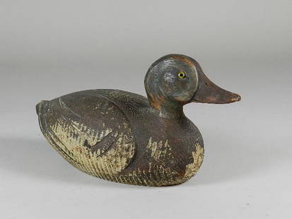 Antique Carved Wood Duck Decoy: Well executed and has glass eyes. Heavy wear to paint. 12" long