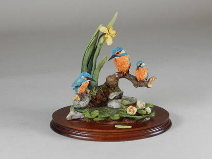 Russel Willis Kingfisher Figurine: One tulip leaf is broken but piece is present. 9 1/2" w x 9 1/2"t